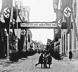 Deutsche Straße, Homburg, gesäumt von Hakenkreuzfahnen und dem Transparent „Frei sind wir, wie unsere Väter waren“, Januar 1935. Foto: ZASP